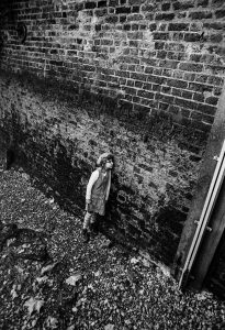Girl With Face Stuck to Wall